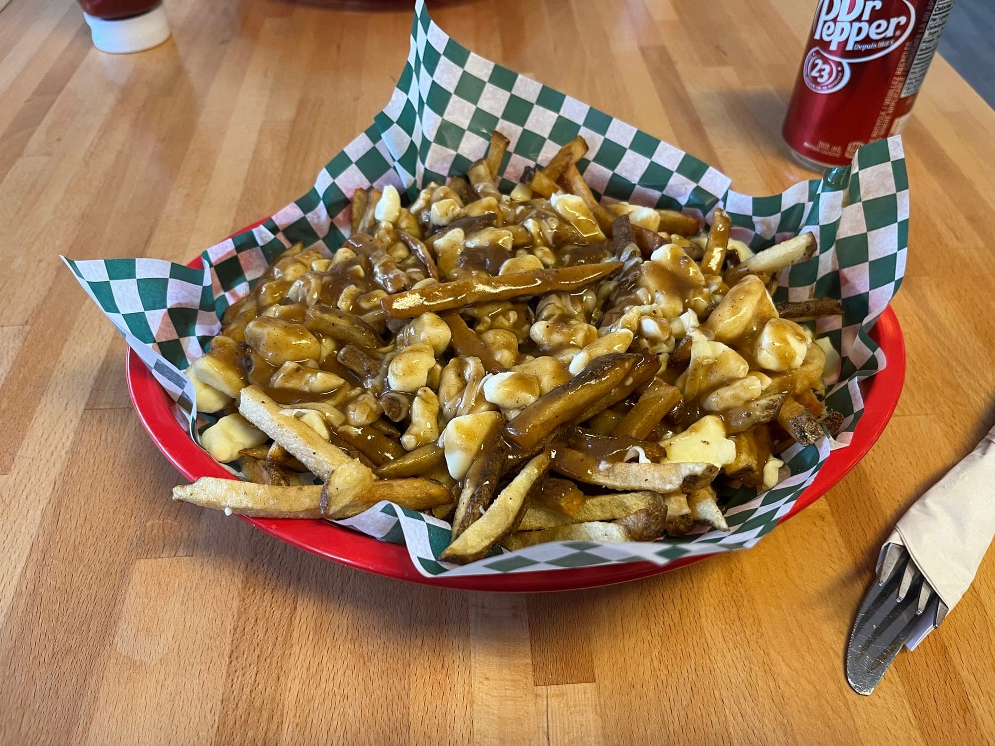 Basket of poutine - Fries covered in cheese curds and gravy