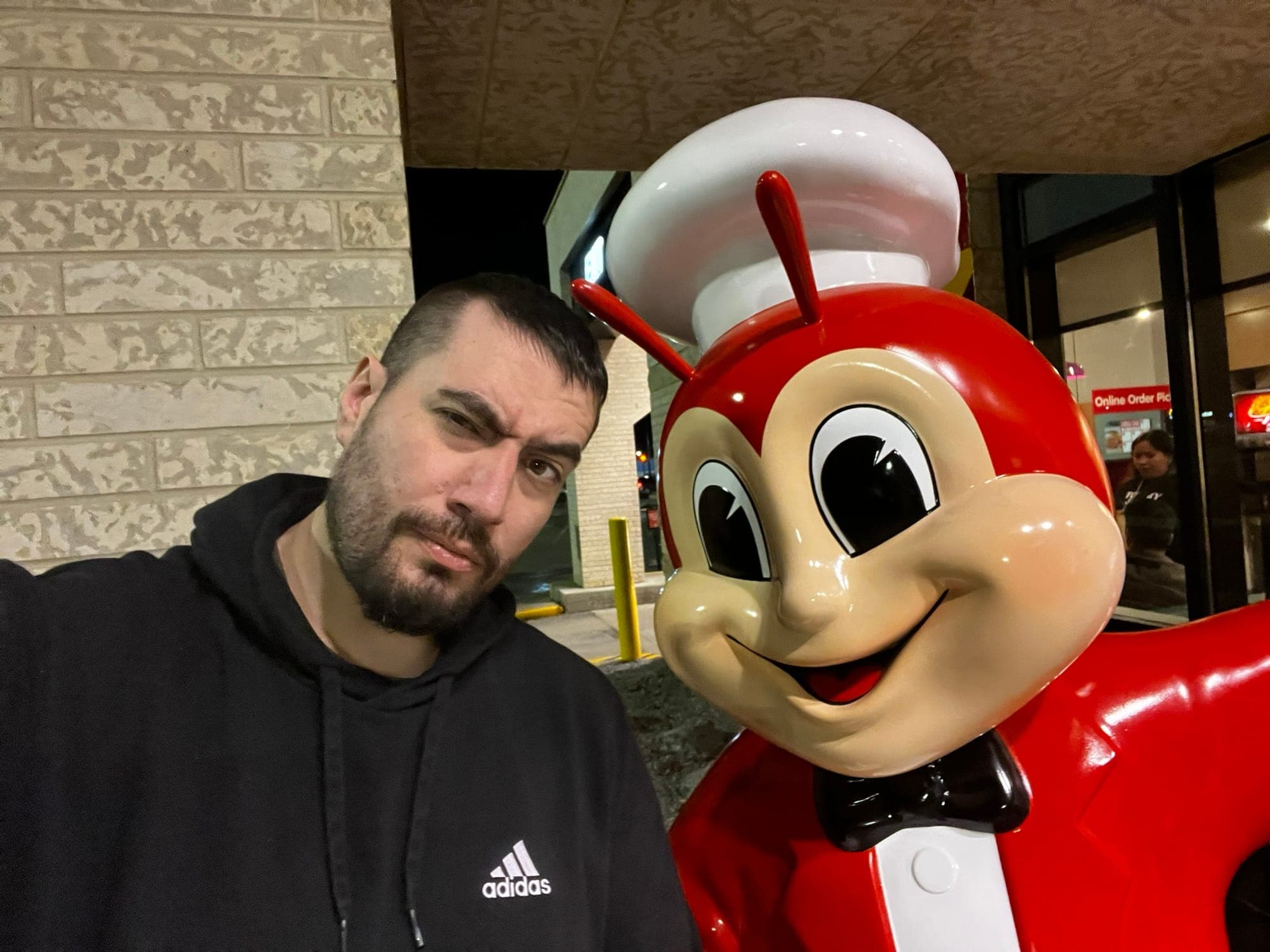 Image of the author standing next to a Jollibee statue.
